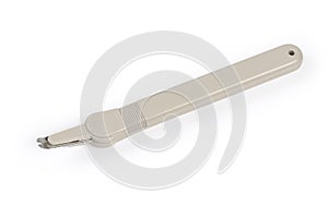 Pen type staple remover on a white background