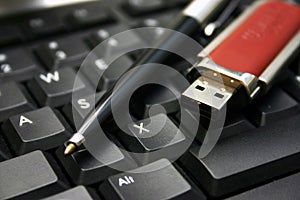 Pen, USB stick and keyboard photo