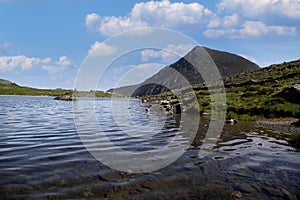 Pen Yr Ole Wen mountain reflected in the water of Llyn Idwal at Snowdonia National Park, North Wales