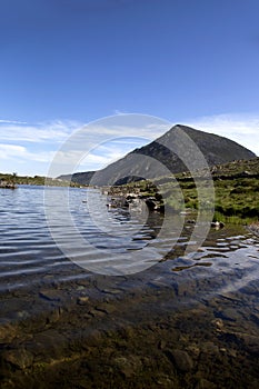 Pen Yr Ole Wen mountain reflected in the water of Llyn Idwal at Snowdonia National Park, North Wales