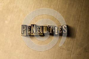 PENALTIES - close-up of grungy vintage typeset word on metal backdrop photo