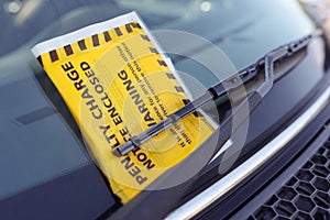 Penalty charge notice parking fine attached to windscreen