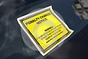 Penalty charge notice parking fine attached to windscreen