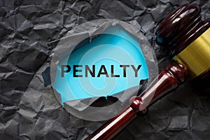 Penalty concept. Torn paper and a gavel as a symbol of justice.