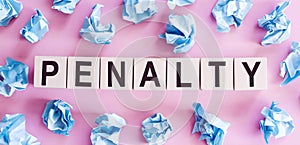 PENALTY word made with building blocks on pink background