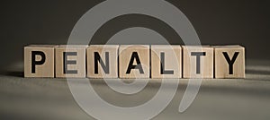 PENALTY word made up of building blocks on gray background