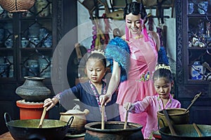 Penang,Malaysia-October 6th,2018:A beautiful adult model posing with two young girls wearing traditional Chinese clothing.Chinese