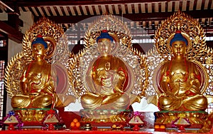 Penang, Malaysia: Three Gilded Buddhas at Chinese Temple photo