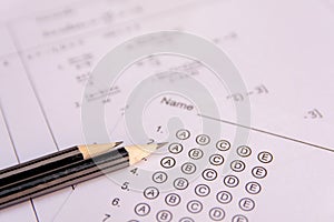 Pencil on answer sheets or Standardized test form with answers bubbled. multiple choice answer sheet