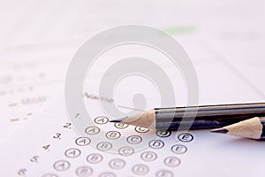 Pencil on answer sheets or Standardized test form with answers bubbled. multiple choice answer sheet photo