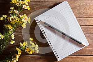 Pencil and book with flowers