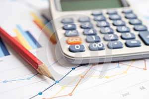 Pencil and calculator on chart or graph paper. Financial, account, statistics and business data concept