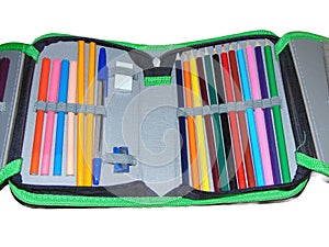 Pencil case with colored pencils, crayons, pen, eraser, sharpener. School concept