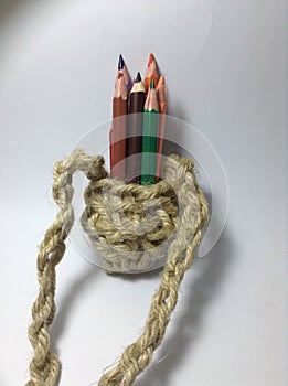 Pencil colours in a crocheted jute holder