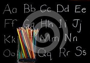 Pencil crayons with chalkboard background