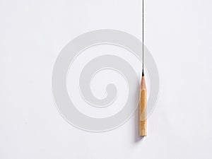 Pencil draws a vertical line on white background. Drawing borders. Stability or stagnancy in business photo