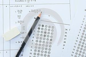 Pencil and eraser on answer sheets or Standardized test form with answers bubbled. multiple choice answer sheet