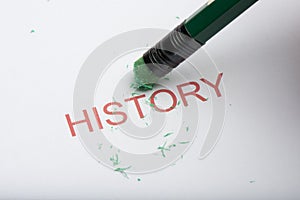 Pencil Erasing the Word `History` on Paper