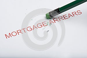 Pencil Erasing the Word `Mortgage Arrears` on Paper