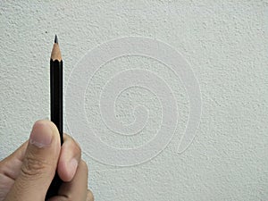 Pencil in a handa with white wall bcakground. photo