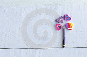 Pencil with an heart erasers lined in the shape of a flower,