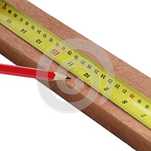 Pencil marking wood with steel measure on white background