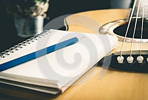 Pencil Notebook on Acoustic guitar for songwriter