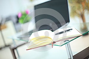 Pencil and notebook on laptop for business concept.