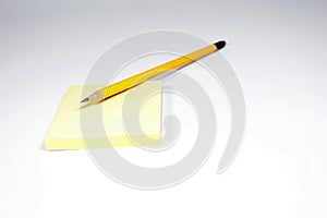 Pencil and notepad on white background