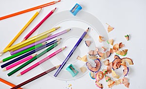 pencil peels from sharpening, sharpeners and a colored pencils
