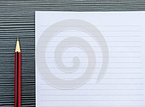 A pencil and a piece of paper on the table