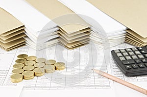 Pencil and pile of gold coins as triangle with calculator