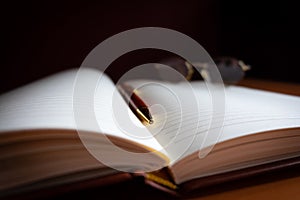 Pencil and reading glasses on a blank journal