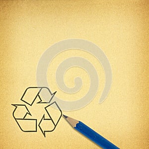 Pencil & recycle symbol on brown paper for texture background