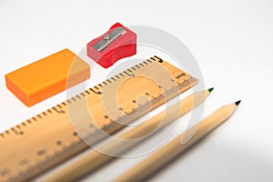 Pencil, ruler, eraser and sharpner isolated on white background photo