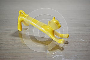a pencil shaped yellow toy cat in a side angle photo