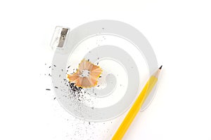 Pencil, sharpener and pencil sawdust isolated on white background