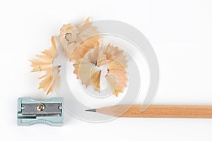 Pencil and sharpener with shavings on white