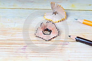 Pencil sharpener shavings on a wooden table. Back to school