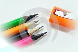 Pencil sharpeners and colored pencils in a pile