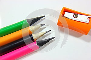 Pencil sharpeners and colored pencils in a pile
