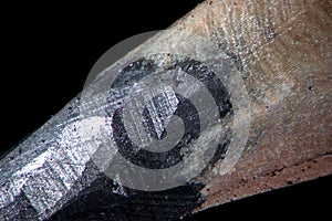 Pencil sharpening. Stationery writing, drawing accessories. Pencil tip super macro close-up. Graphite lead by microscope