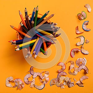 Pencil shavings on the yellow background