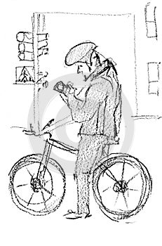 Pencil sketch. A male cyclist has stopped at a traffic light. He is looking at his mobile phone.