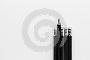 Pencil standing out from row of pencils.