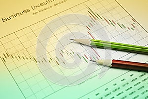 Pencil on stock market graph, Business investment concept