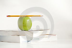 Pencil on top an Apple