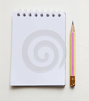 Pencil and white paper note book
