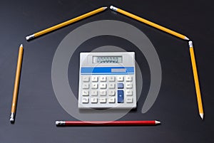 Pencils as house with calculator door