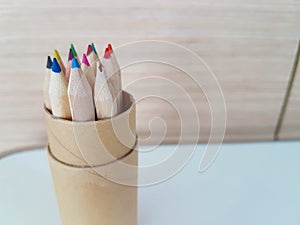 Pencils in a box with one broken pencil